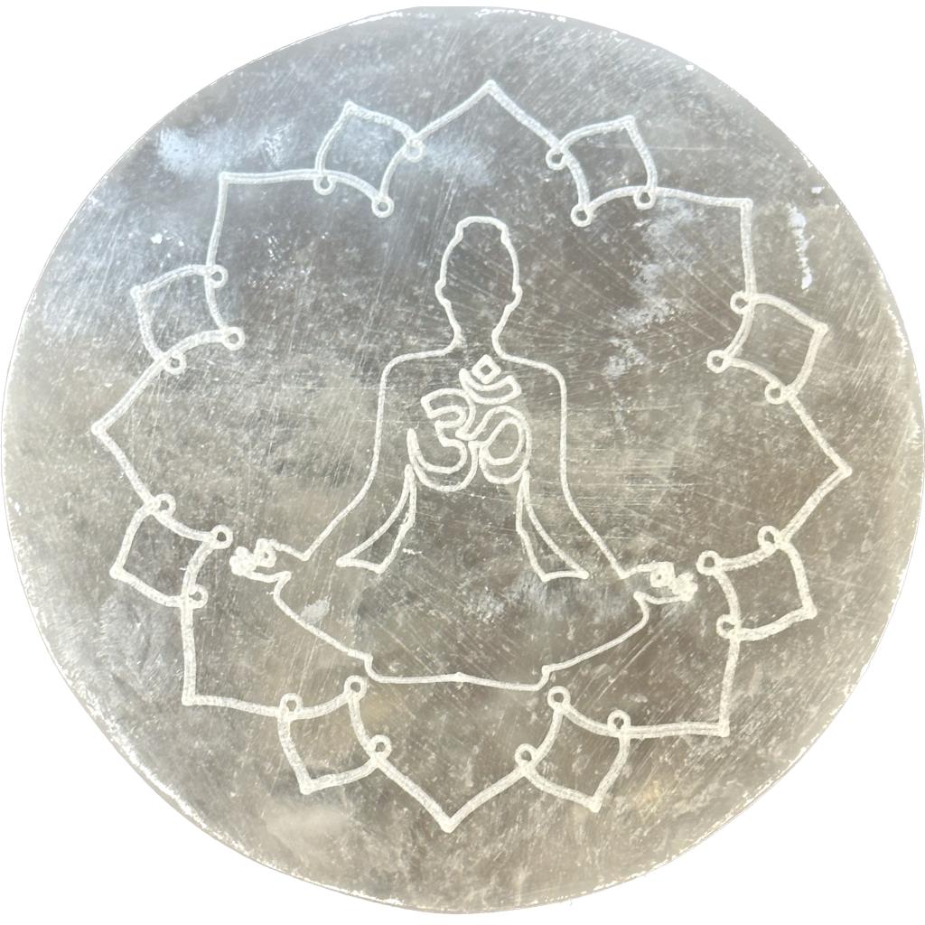 This is a picture of a selenite charging disc for minerals, it has the Reiki symbol carved on it.