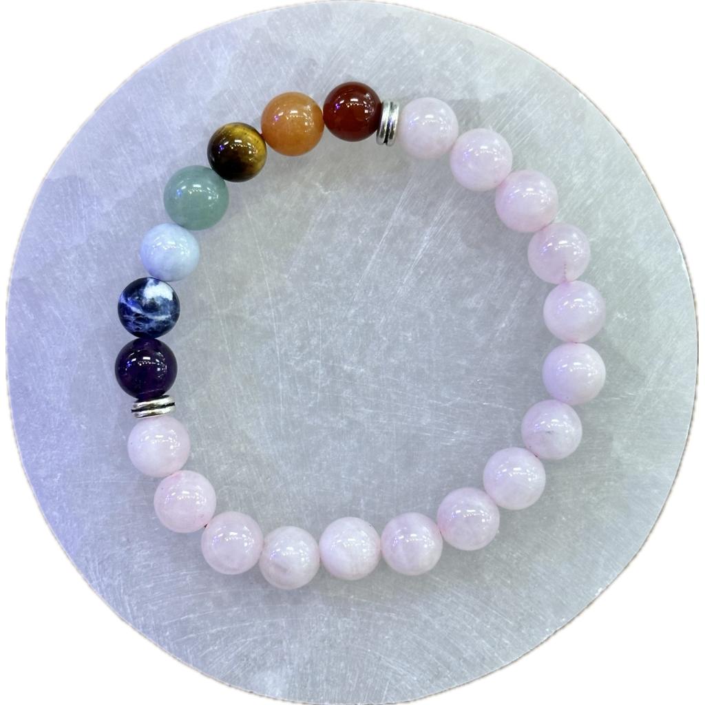 This is a picture of a Metaphysical bracelet, made out of Rose Quartz and a variety of minerals representing the 7 Chakras.