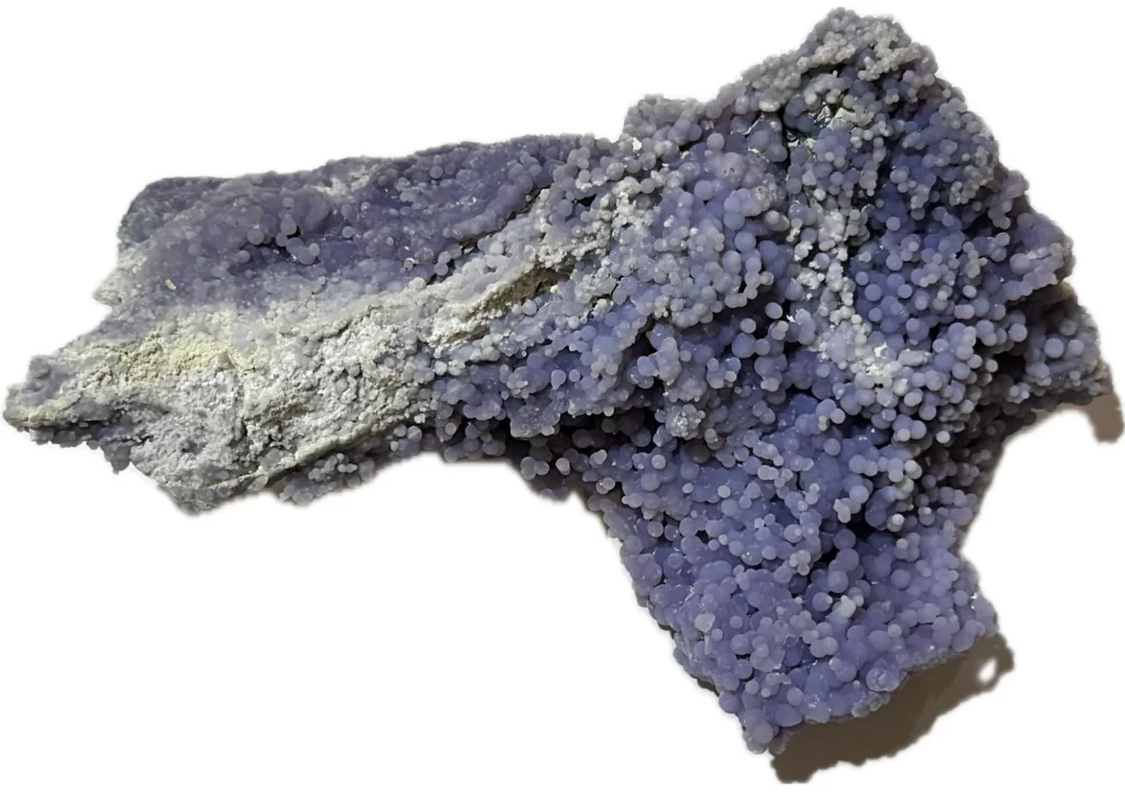 This is a picture of an oddly-shaped grape agate cluster. It is lavender in color and has a white background.