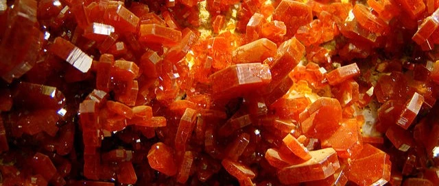 This is an up-close picture of a Vanadinite cluster. It is a deep, orange red.