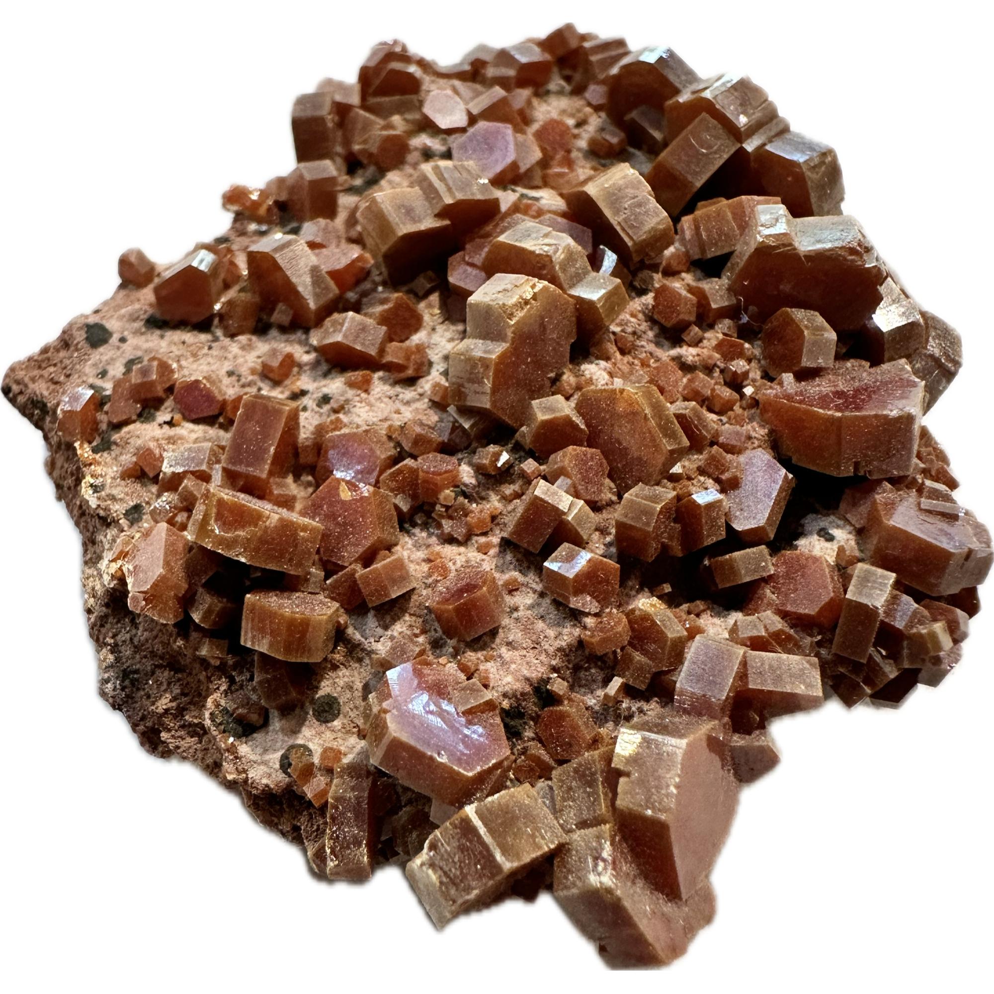 Pale red crystals can be observed on this vanadinite cluster. They are all blocky in shape.