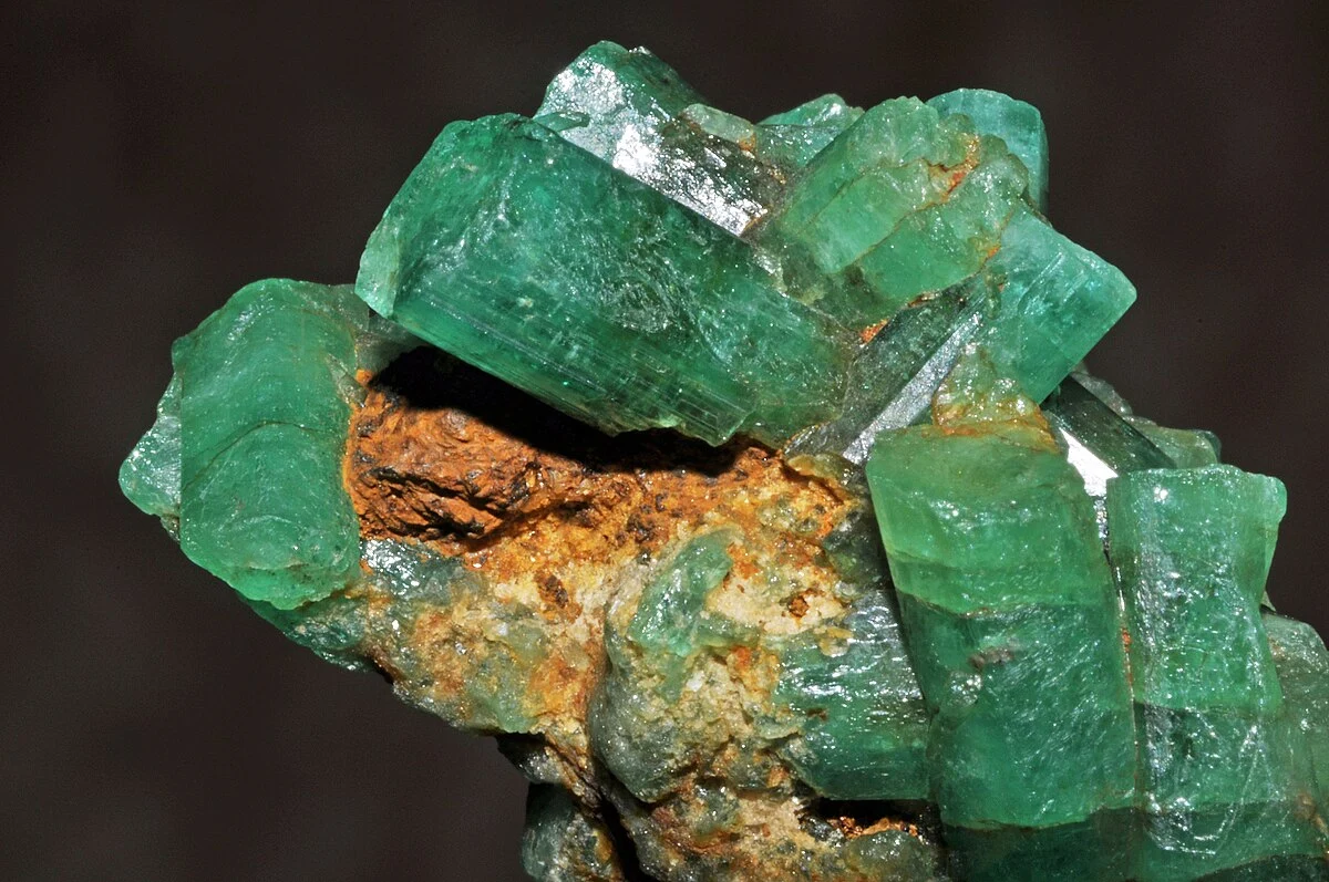 This is a picture of a raw emerald cluster from the Muzo Mines in Colombia. The color is a pleasantly bright green.