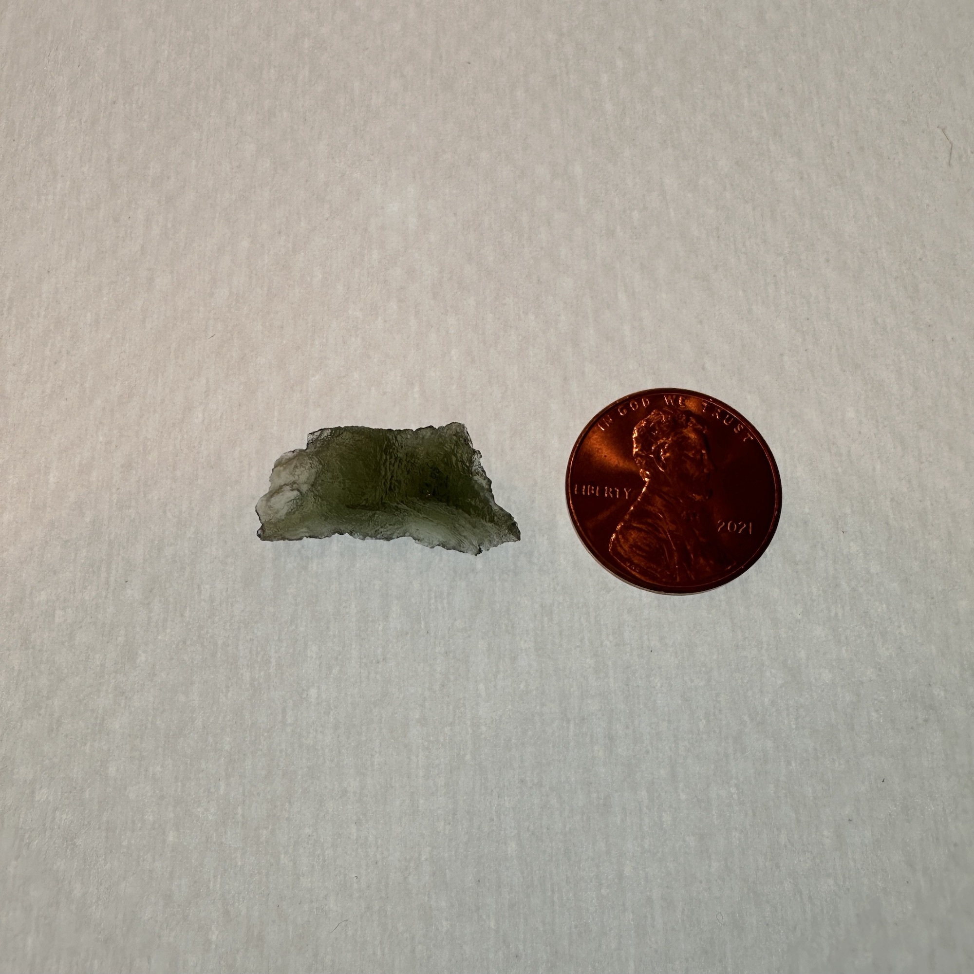 This beautiful light green translucent meteorite glass Moldavite was found in the Czech Republic