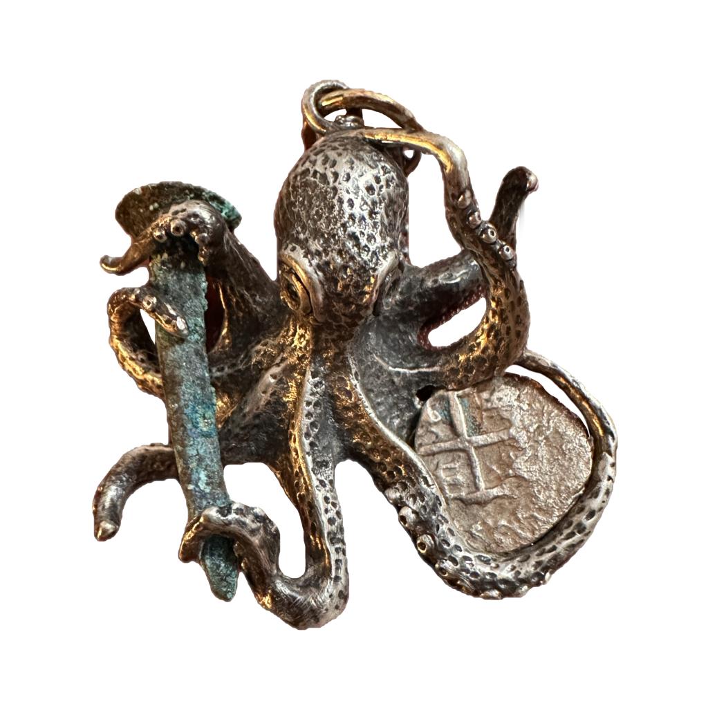 This pendant is a sterling silver octopus design with a shipwreck copper nail and a 1/4 Reale silver coin. This one of a kind pendant was designed by U-boat Hunter, Darrell Miklos.